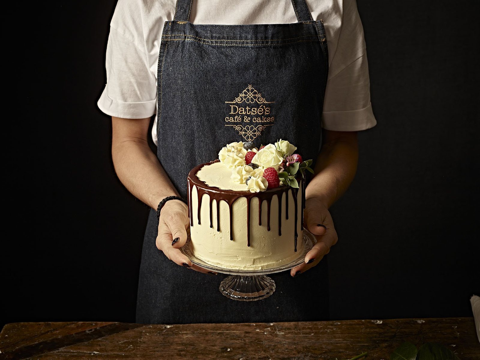 A homemade chocolate drip cake with berries at Datsé’s Café and Cakes